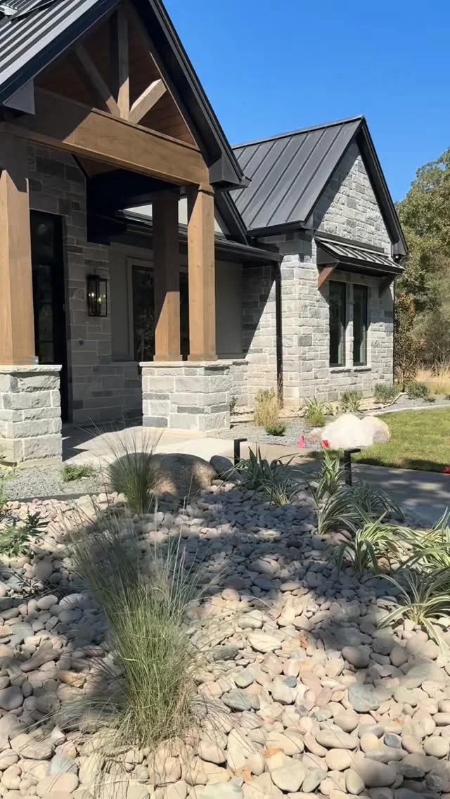 A finished Tredway custom home in stone and timber with native landscaping