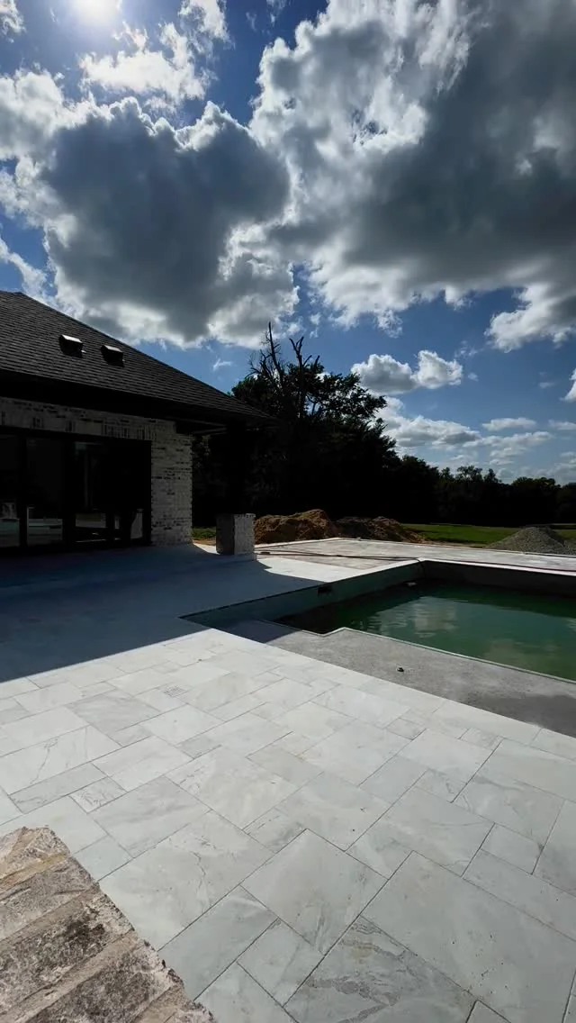 A pool and covered outdoor living area on a Tredway custom home