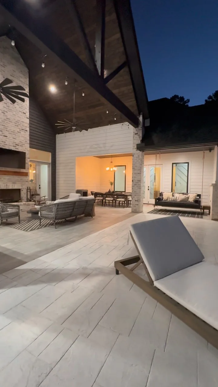 A pool and covered outdoor living area on a Tredway custom home