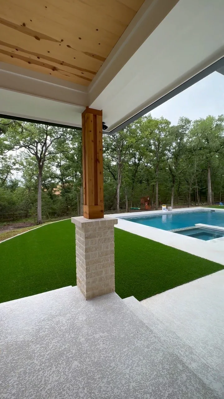 A pool and covered outdoor living area on a Tredway custom home