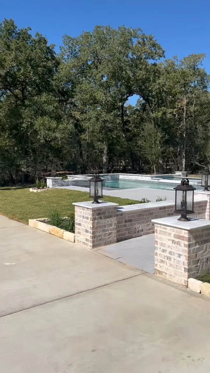 A pool and covered outdoor living area on a Tredway custom home